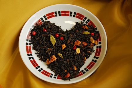 Spicy black tea Cristmas cookies with buds of a clove, a coriander, slices of apples, oranges, pink pepper. Very tasty and aromatic, tones up and improves digestion.A great gift for your beloved.の写真素材
