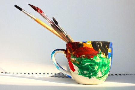 Art paint brushes in a cup with empty space for textの写真素材