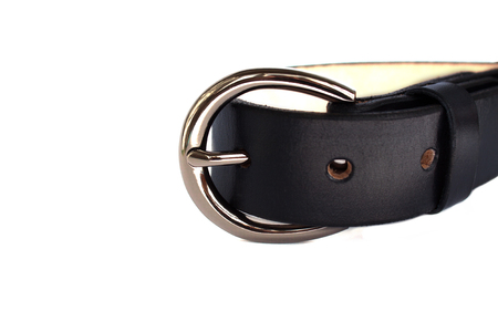 Fastened fashionable black leather belt with shiny chrome metal buckle isolated on white background.の写真素材