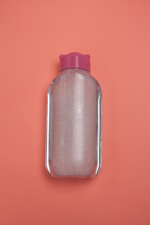 Skincare cosmetic bottle, product for cleansing and make-up remove, top view. Facial tonic, miccelar water for skincare. Mock-up for branding, copy space, pastel color background, minimalistic style.の写真素材