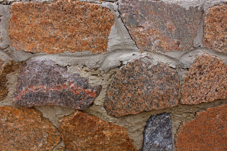 Red and grey stones wall background, texture of modern style design, copy space. Stone fence, gab ions with cement.の写真素材