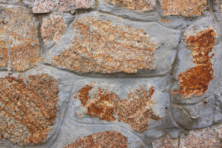 Red and grey stones wall background, texture of modern style design, copy space. Stone fence, gabions with cement.の写真素材