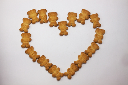 Cute bears cookies heart shaped pattern isolated on white background. Breakfast time for lovers, sweets, bakery, confectionery, forever together. View from above, flat lay.の写真素材