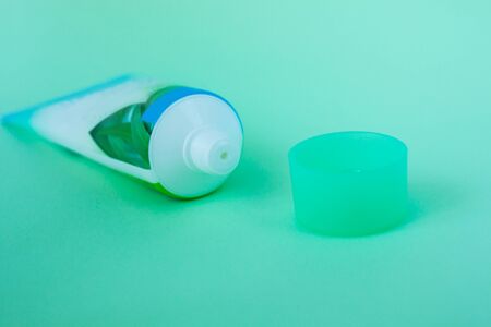 Tube with cream on a pastel mint color background, cosmetics care concept. Pacaging of beauty products, scincare treatments, body lotion, gel, branding mock-up, minimalistic style.の写真素材