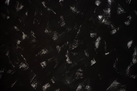 Black board with white paint brush strokes texture, dark background, black and white dingy wall backdrop wallpaper, deep tone, copy space.の写真素材