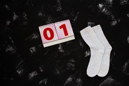 White socks and school supplies on black background. The first of september, 1 class, 01 numbers, zero and one cards. Back to school banner, education concept. Top view, flatlay, copy space.の写真素材