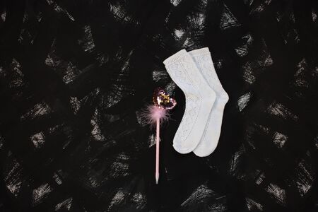 White socks and school supplies on black background. Back to school banner, education concept. Pink heartshaped glitter pen with feathers. Top view, flatlay, copy space.の写真素材