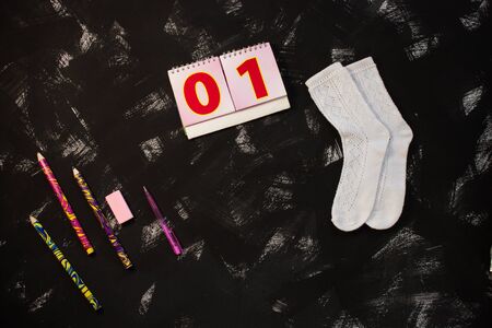 White socks and school supplies on black background. The first of september, 1 class, 01 numbers, zero and one cards. Back to school banner, education concept. Top view, flatlay, copy space.の写真素材