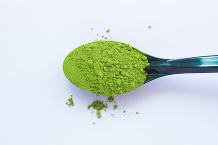 Matcha green tea on light background. A spoon with traditional powdered japanese tea. Healthy drinks, weightloss remedy, energy and antioxidant sourse. Copy space, top view, flatlay.の写真素材