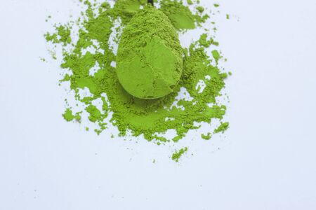 Matcha green tea on light background. A spoon with traditional powdered japanese tea. Healthy drinks, weightloss remedy, energy and antioxidant sourse. Copy space, top view, flatlay.の写真素材