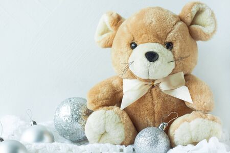 New Year card in metal silver colors. Symbol of New Year 2020 - rat. Cute rat with ribbon bow and Christmas decorations and white knitted plaid. Copy space, front view.の写真素材