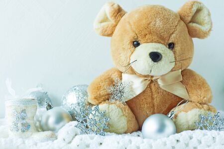 Christmas card in metal silver colors. Symbol of New Year 2020, cute rat soft toy with ribbon bow, New Year decorations, snowflakes, balls and white crocheted plaid. Copy space, front view.の写真素材