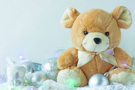 Christmas card in metal silver colors. Symbol of New Year 2020, cute rat soft toy with ribbon bow, New Year decorations, snowflakes, balls and white crocheted plaid. Copy space, front view.の写真素材
