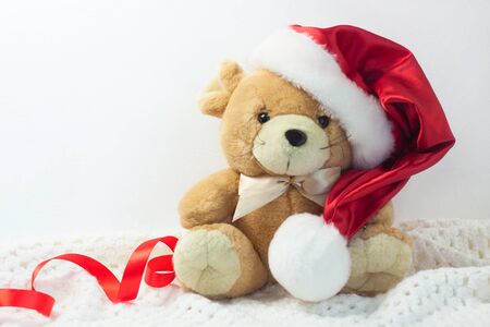 Christmas card with symbol of the year 2020 a rat in a red Santa hat and ribbon bow on a white background. Soft toy, cute New Year animals, copy space, front view.の写真素材