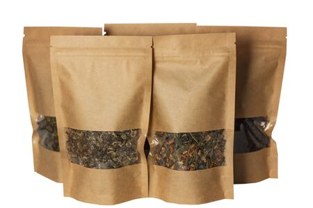 Brown kraft paper pouch bags front view isolated on a white background. Packaging for foods and goods template mock-up. Packs with clasps and windows for tea leaves, coffee beans and weight products.の写真素材