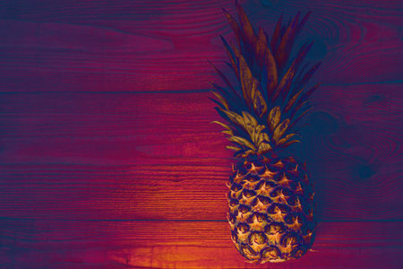 Neon pineapple background, flatlay. Healthy ftropical fruits diet, vegan food banner, color trends wallpaper. Minimal photo, creative social media picture top view. Minimalism style, trendy toning.の写真素材
