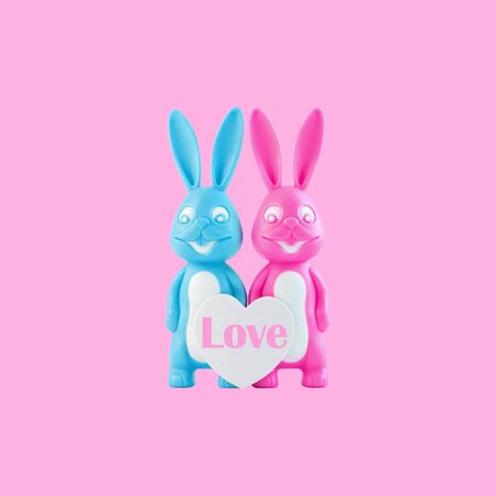 Valentine's day card, cute bunnies happy lovers couple with white heart on trendy pink background. Family love, dating concept.Easter banner. Purple and blue rabbits.Creative minimal style,copy spaceの写真素材