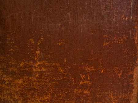 Rusty metal background. Red corroded texture. Damaged surface for text design. Old orange rust backdrop. Architecture exterior detail.の写真素材