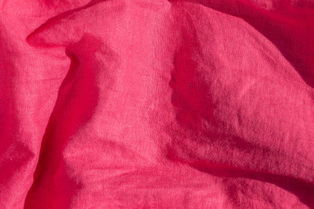 Pink linen fabric texture top view. Red coral background. Fashion color feminine clothes trends....