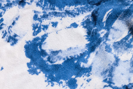 Tie-dye cotton fabric texture blue and white paint colors. Ancient resist-dyeing textile coloring...