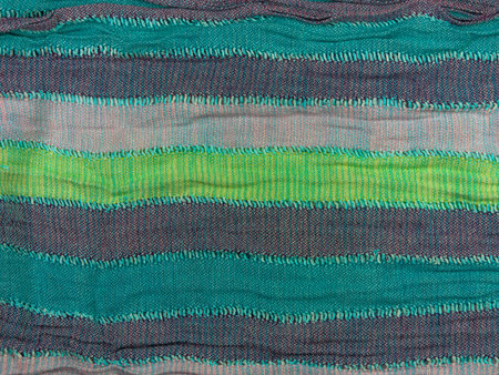 Striped knitted cotton fabric matte texture top view. Colorful stripes knitwear background. Fashion...