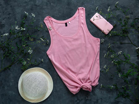Pink cotton tank top mockup on dark background. Blank plain t-shirt template for creative design. Female summer sunglasses clothing fashion sleeveless undershirt. Casual clothes website social media.の写真素材