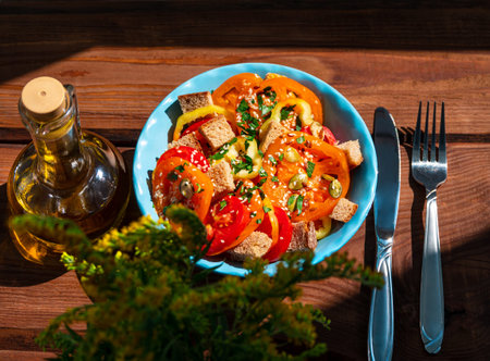 Panzanella traditional italian mixed tomatoes olive oil and bread salad in blue ceramic bowl on...
