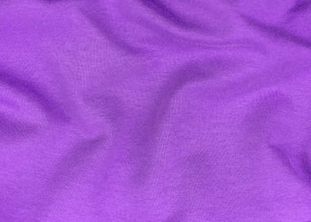 Purple jersey fabric matte texture top view. Violet knitwear satin background. Fashion color feminine clothes trend. Female blog backdrop text sign design. Lilac abstract wallpaper textile surface.の写真素材
