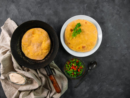 Homemade corn flatbread on frying pan cilantro tomato salsa linen cloth. Handmade mexican cheese...