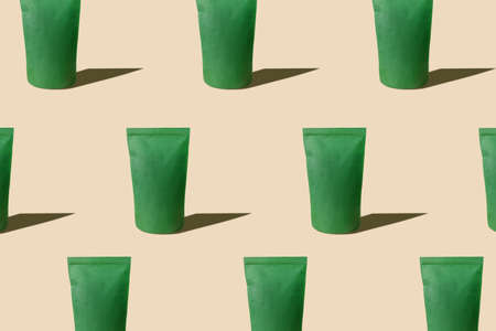 Green pouch bag mockup pattern neutral beige background harsh shadows. Blank emerald recycled paper pack coffee beans advertising. Packaging template food delivery matcha tea product merchandise shopの写真素材