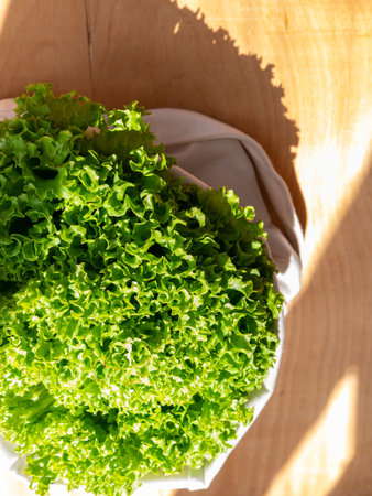 Fresh lettuce salad in eco shopping bag top view. Sustainable living Shop local concept. Green leaf...