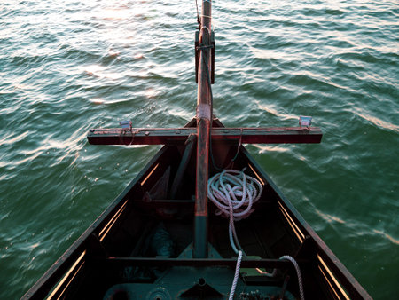 Sailboat bow with mooring rope sailing on the sea waves with turquoise water top view. Atmospheric...