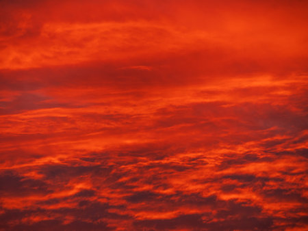 Sunset in the mountains with orange red sky and clouds. Winter Carpathian Mountains view cloudscape. Pine fir tree forest in Carpathians Scenic wood landscape Village in Transcarpathia Ukraine, Europeの写真素材