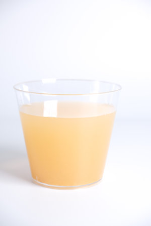 Apple juice in plastic cupの写真素材