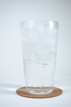 Soda drink in glass with ice, close up