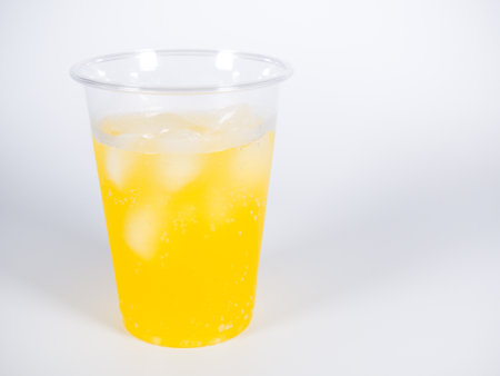 Orange juice in plastic cupの写真素材