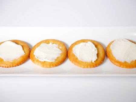 Round crackers with cream cheeseの写真素材
