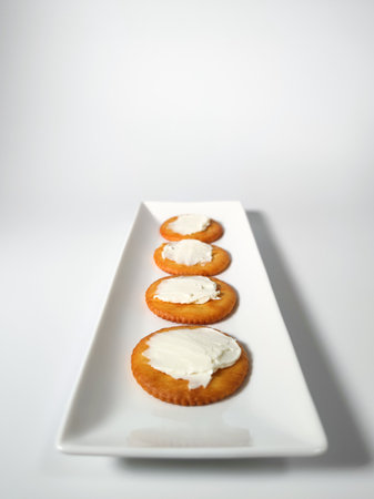 Round crackers with cream cheeseの写真素材