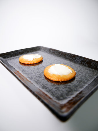 Round crackers with cream cheeseの写真素材