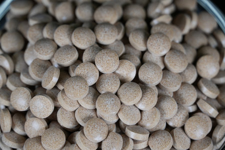 Supplement brown tablet black backgroundの写真素材