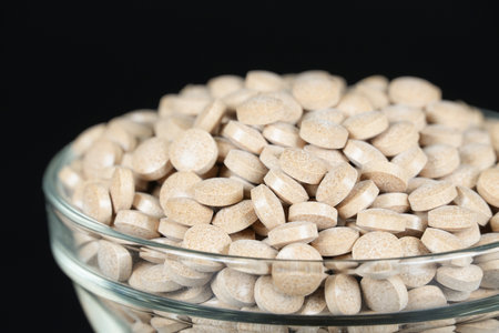 Supplement brown tablet black backgroundの写真素材