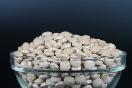 Supplement brown tablet black backgroundの写真素材