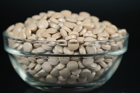 Supplement brown tablet black backgroundの写真素材