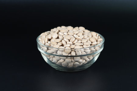 Supplement brown tablet black backgroundの写真素材