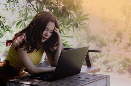 Women working at home with stress. Work on the computer online. The result of the work was not successful. And does not reach the target balance.の写真素材