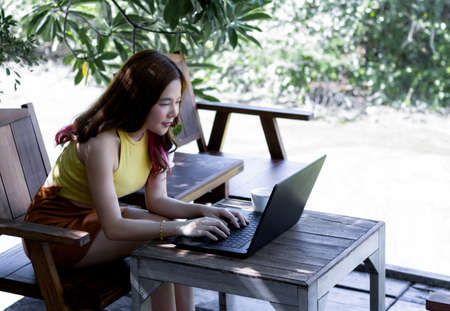 Young business woman work at home by computer via high speed internet. Communication between people through social media. In order to make a social distancing.の写真素材