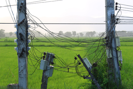 The wires tied on the pole No neatnessの写真素材