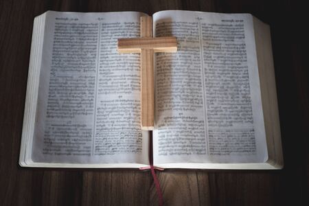 Bible and crucifix. A young woman asks blessings from God with the power and power of holiness, which brings luck and shows forgiveness with the power of religion, faith, worship, Christian thought.の写真素材