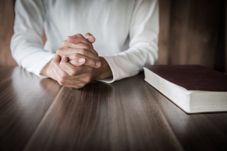 The girl wishes to God. In the hand there was a cross and placed on the Bible. Concept of prayer,...