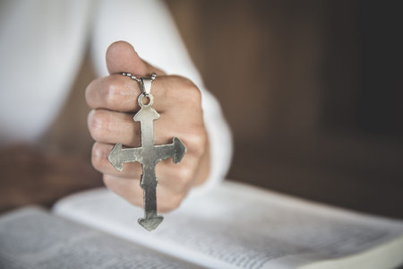 In the hands of the young lady there was a cross and placed in the Bible. Considered as the sacred...